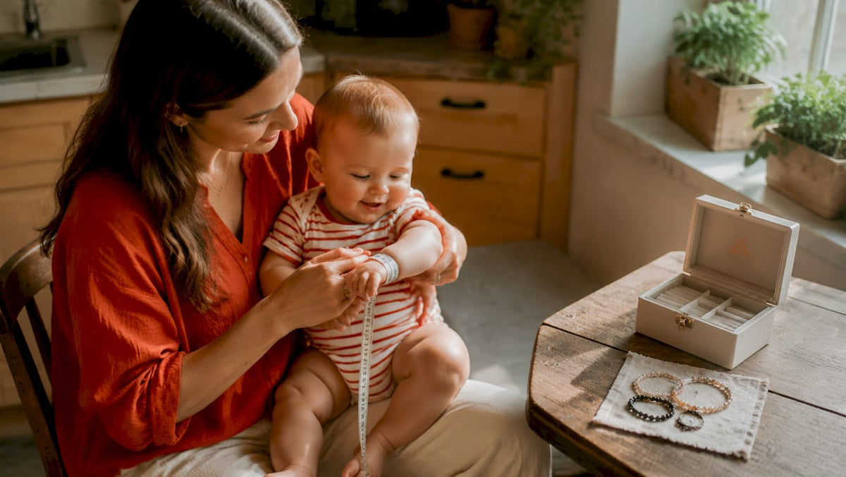 Mother measuring infant wrist for bracelet