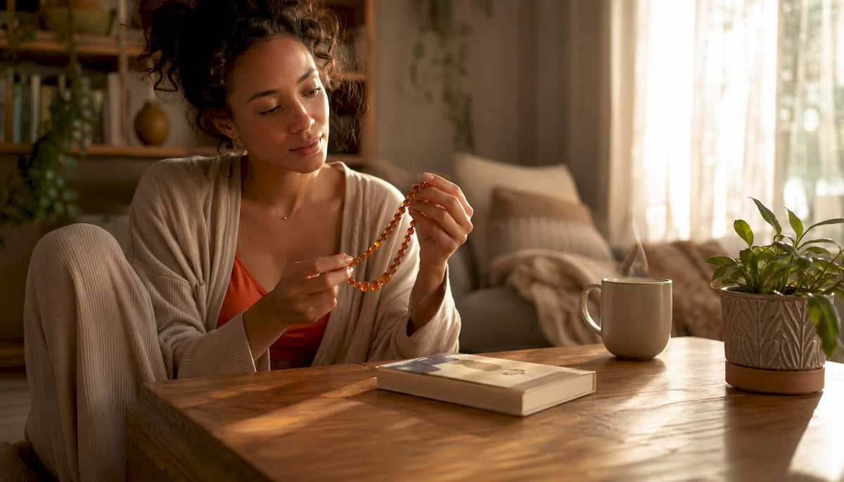 Mother inspecting amber teething necklace thoughtfully