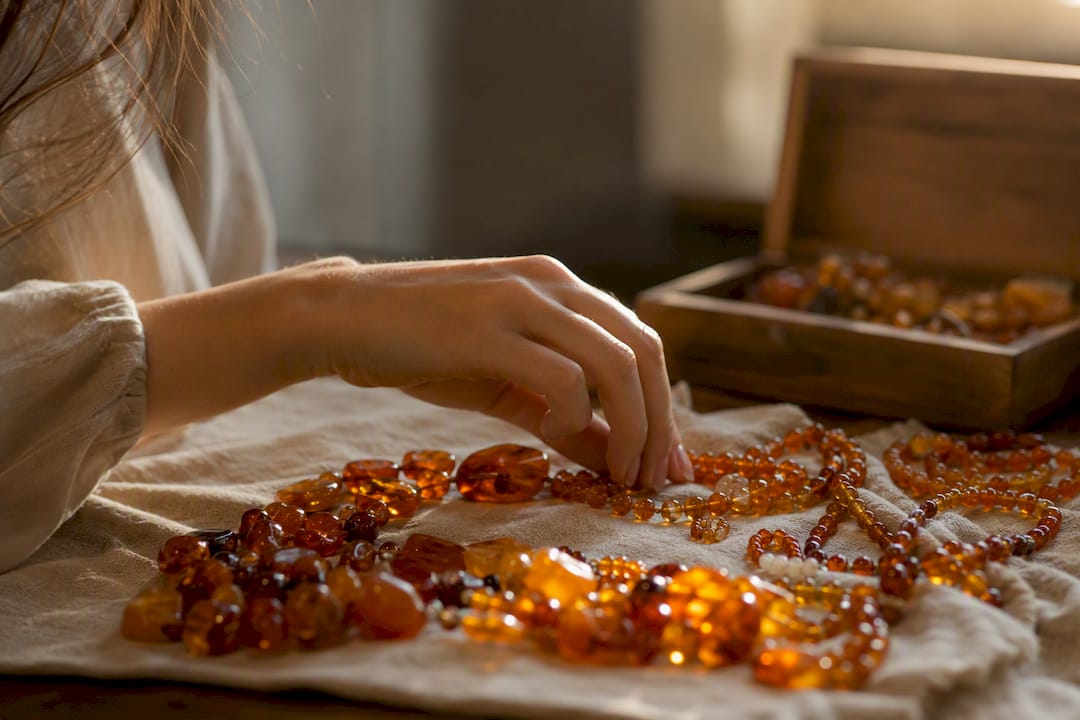 Hand selecting amber jewelry beads
