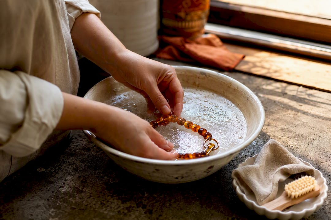 Hands wiping amber pet collar